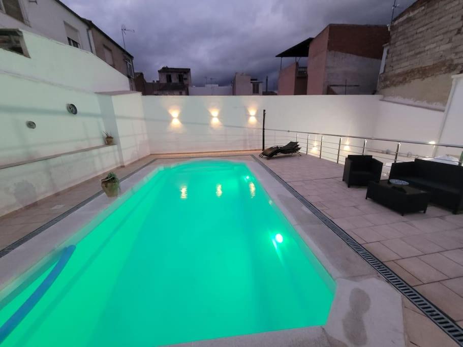 a swimming pool with a green pool at Maison Clémence in Cabra del Santo Cristo