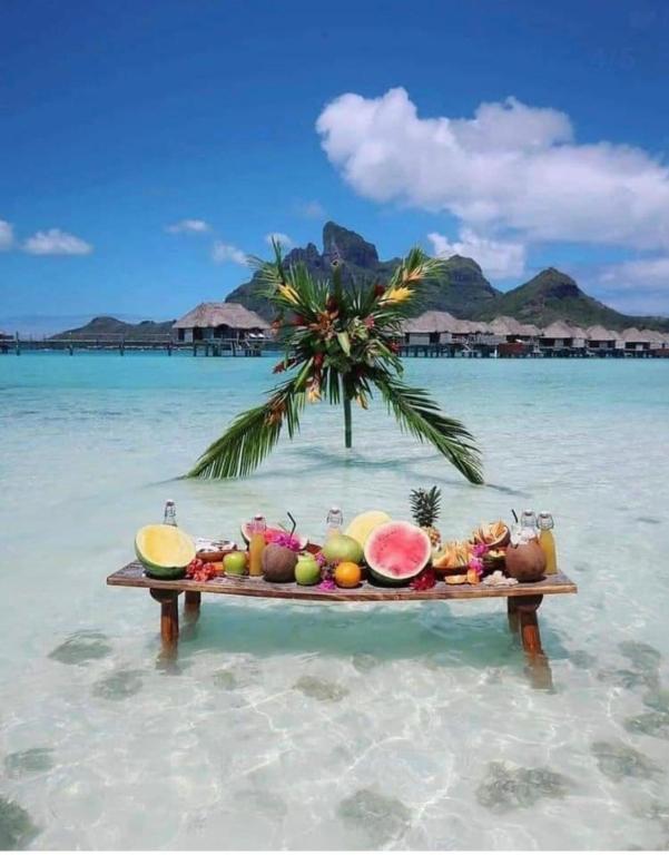 a table of fruit in the water on a beach at New villa on the marina sea in Ash Shihābīyah