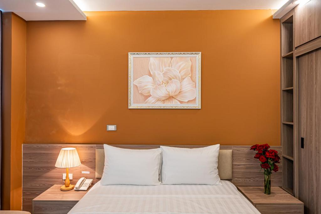 Postel nebo postele na pokoji v ubytování Moon Hotel 26 Do Quang
