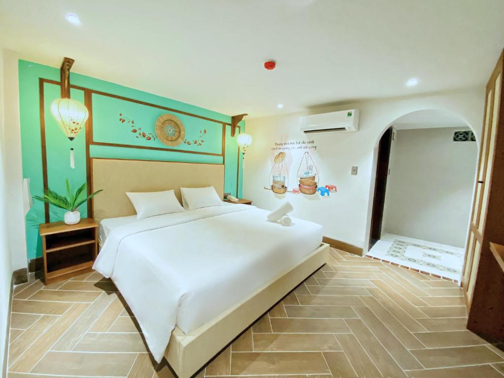 Postel nebo postele na pokoji v ubytování Sujet Hotel Da Nang