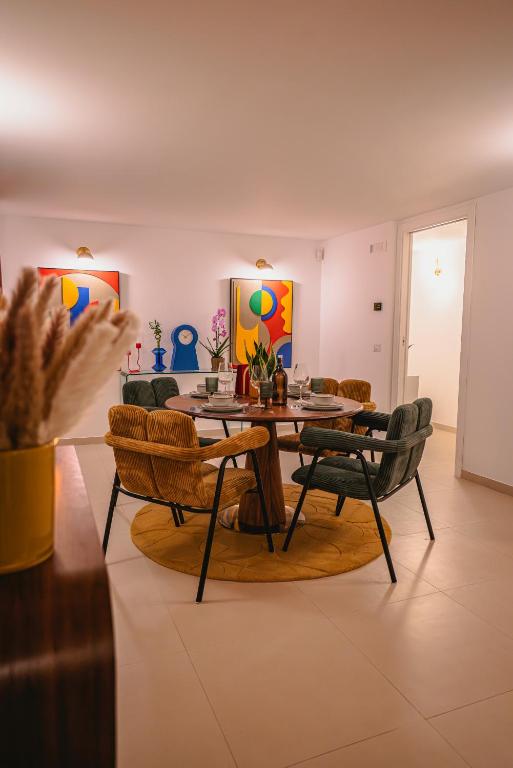 a living room with a table and chairs at Bitter 26 Apartment - Vinto House Collections in Nocera Superiore