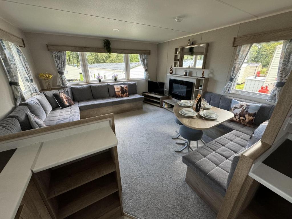 a living room with a couch and a table at West Lawn 47 Haggerston Castle Paddock Views in Berwick-Upon-Tweed