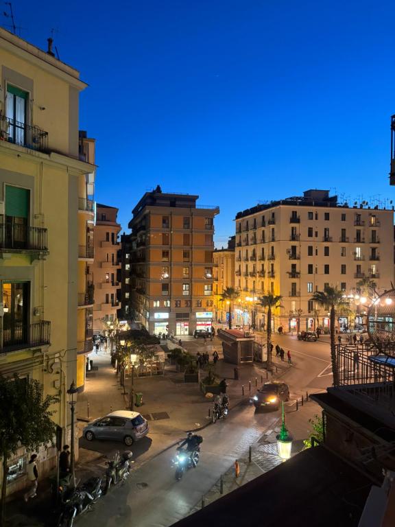 a city street at night with cars and buildings at Urban Chic Guest House free Wi-Fi- in Salerno