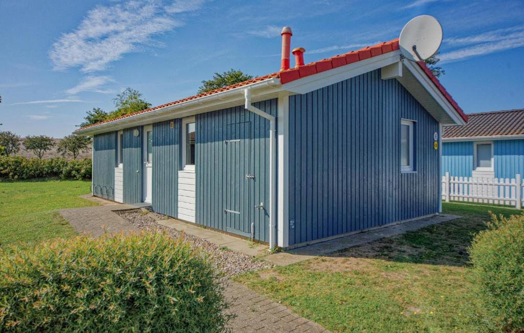 a blue and white building with a satellite at Friedrichskoog-Deichblick 6 in Friedrichskoog