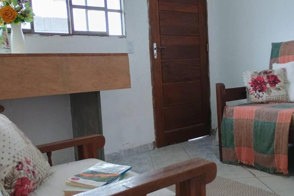 a living room with a fireplace and a bed at Recanto massaguaçu in Massaguassu