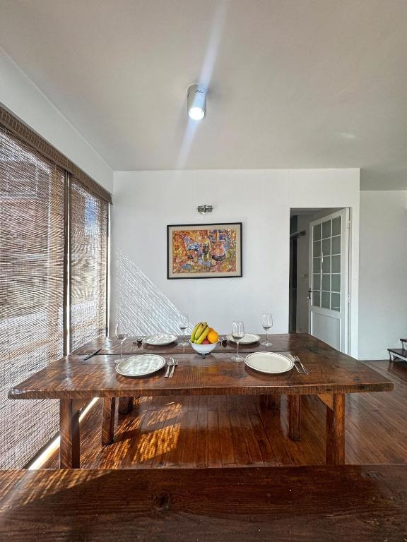 a dining room with a wooden table with plates on it at Ananya Apartments Phase 1 in Kathmandu