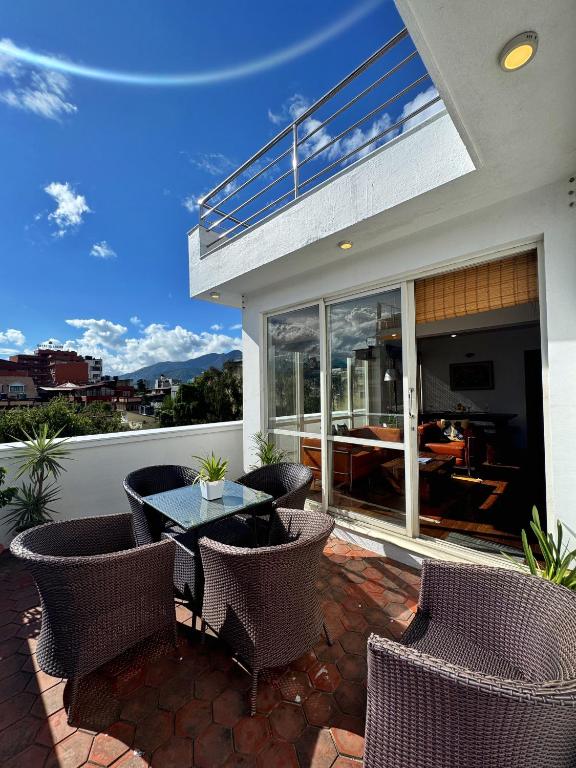 a patio with wicker chairs and a table on a balcony at Ananya Apartments Phase 1 in Kathmandu