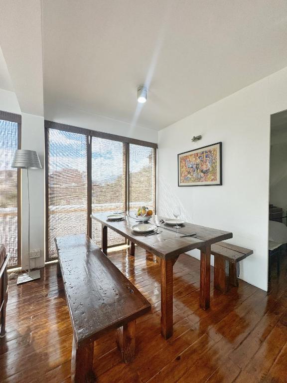 a dining room with a table and a bench at Ananya Apartments Phase 1 in Kathmandu