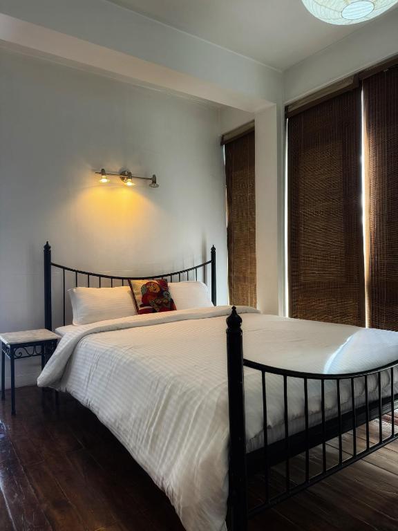 a bedroom with a large bed and a window at Ananya Apartments Phase 1 in Kathmandu