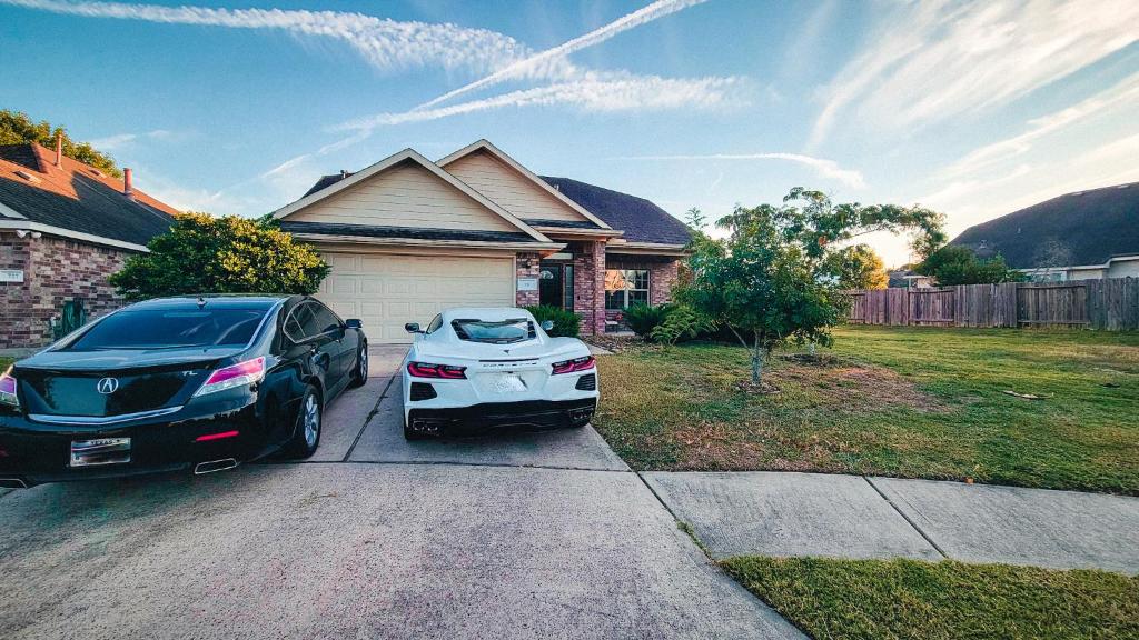a car parked in the driveway of a house at Springwood Executive Home near Exxon Campus in Spring