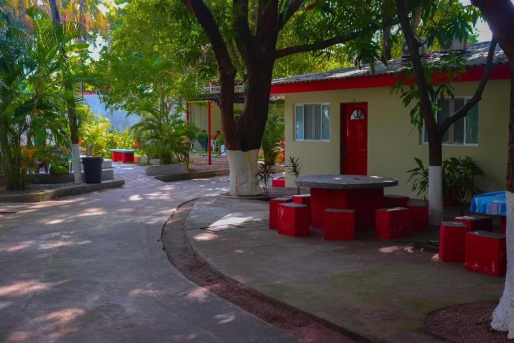 a building with a picnic table and trees in front of it at Olas del mar in La Libertad