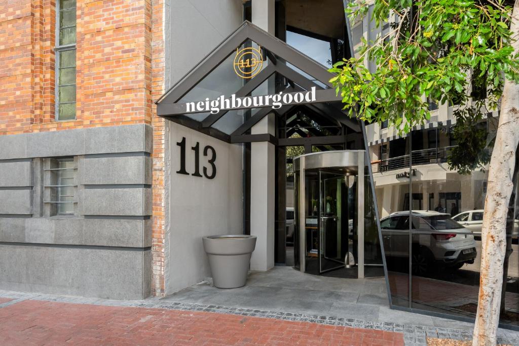 a entrance to a building with a sign on it at Neighbourgood Loop Street in Cape Town
