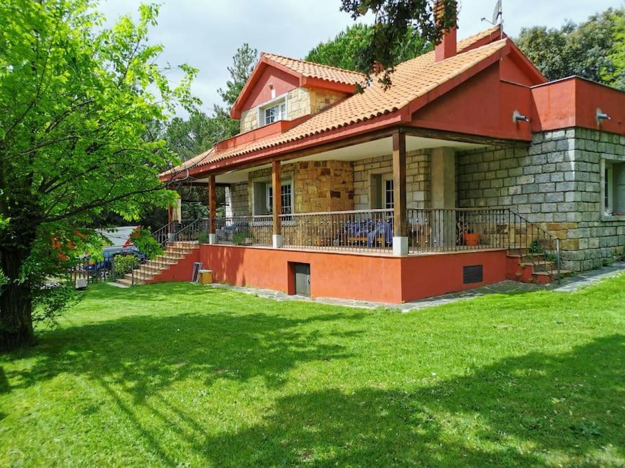 a house with a large yard in front of it at Casa rural chimenea y barbacoa in Escorial