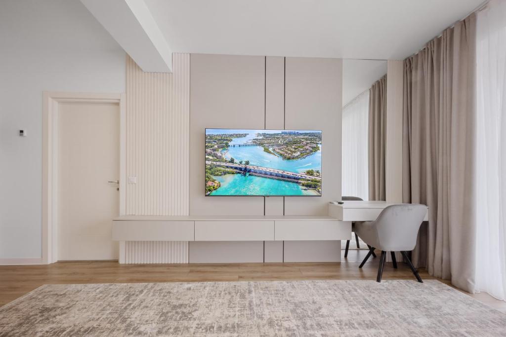 a living room with a tv on a wall at Uno Deluxe Home Brasov in Braşov