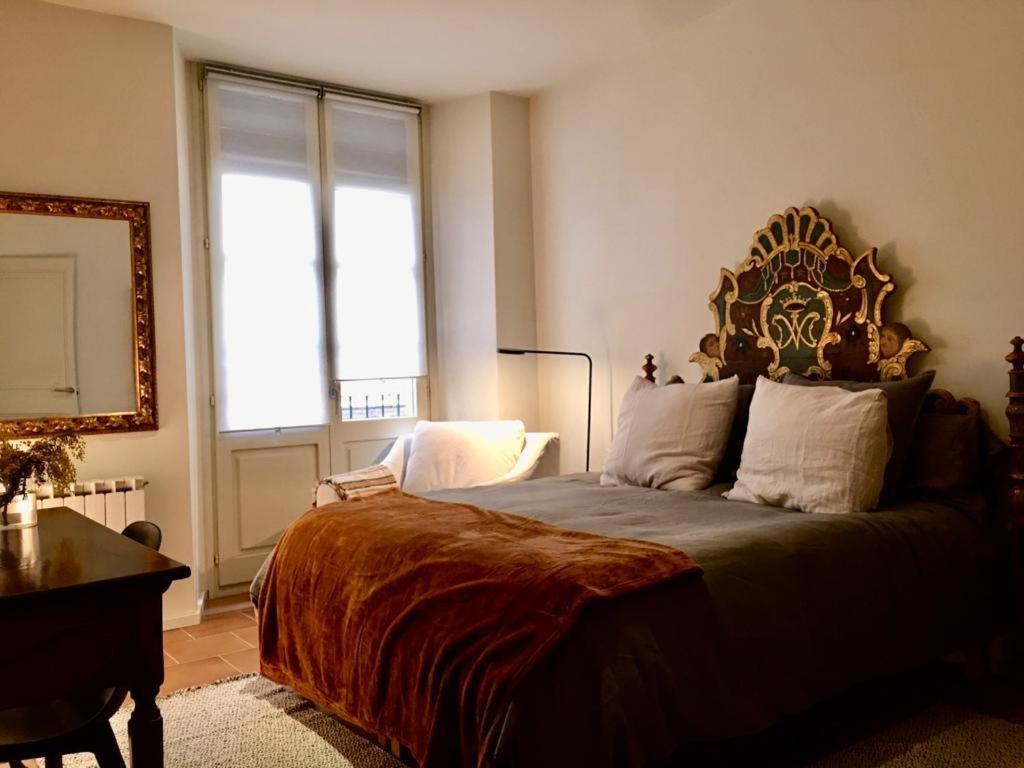 a bedroom with a large bed and a window at Força Old Town in Girona