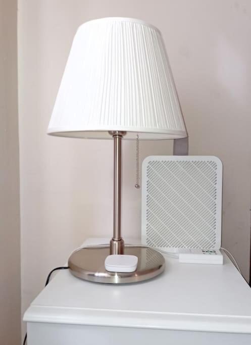a lamp sitting on top of a white table at Leuke Appartement in Ijmuiden in IJmuiden