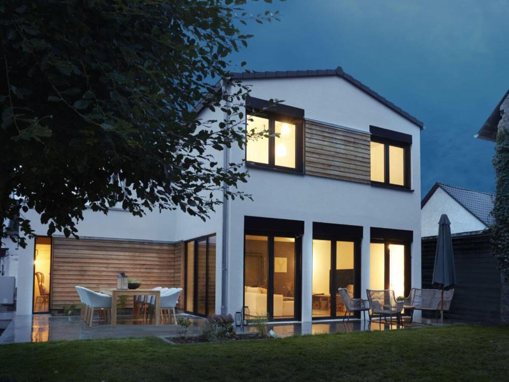 a white house with a table and chairs at Holiday home Chalet 48 in Mayen
