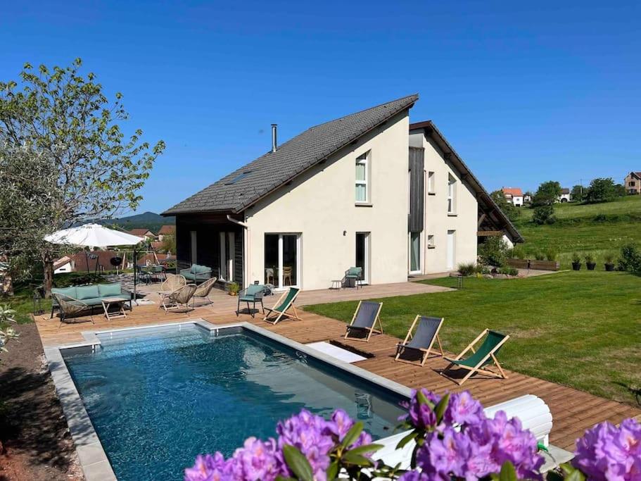 a house with a swimming pool in front of it at LA MAISON DES VOSGES Nature & Pool in Senones