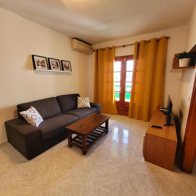 a living room with a couch and a coffee table at Casa Pancho Lanzarote in Playa Honda