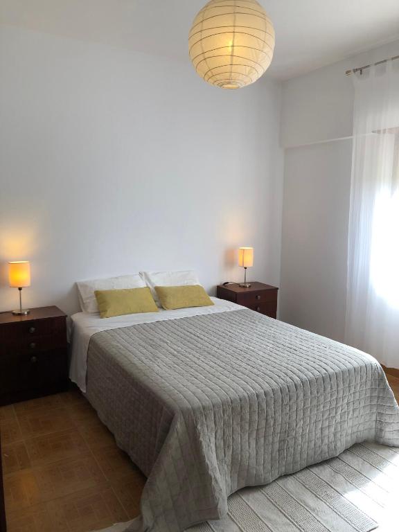 a bedroom with a large bed with two night stands at Casa da Bisa in Sagres