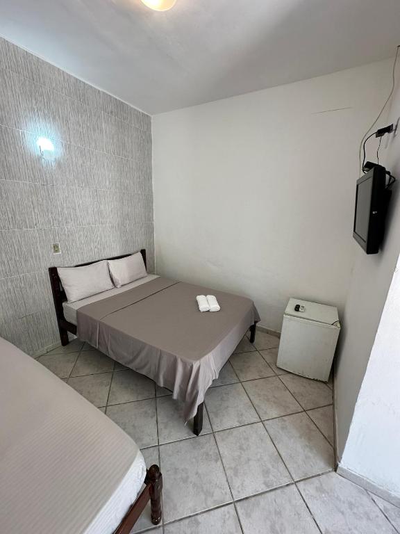 Postel nebo postele na pokoji v ubytování Pousada 3 Irmãos