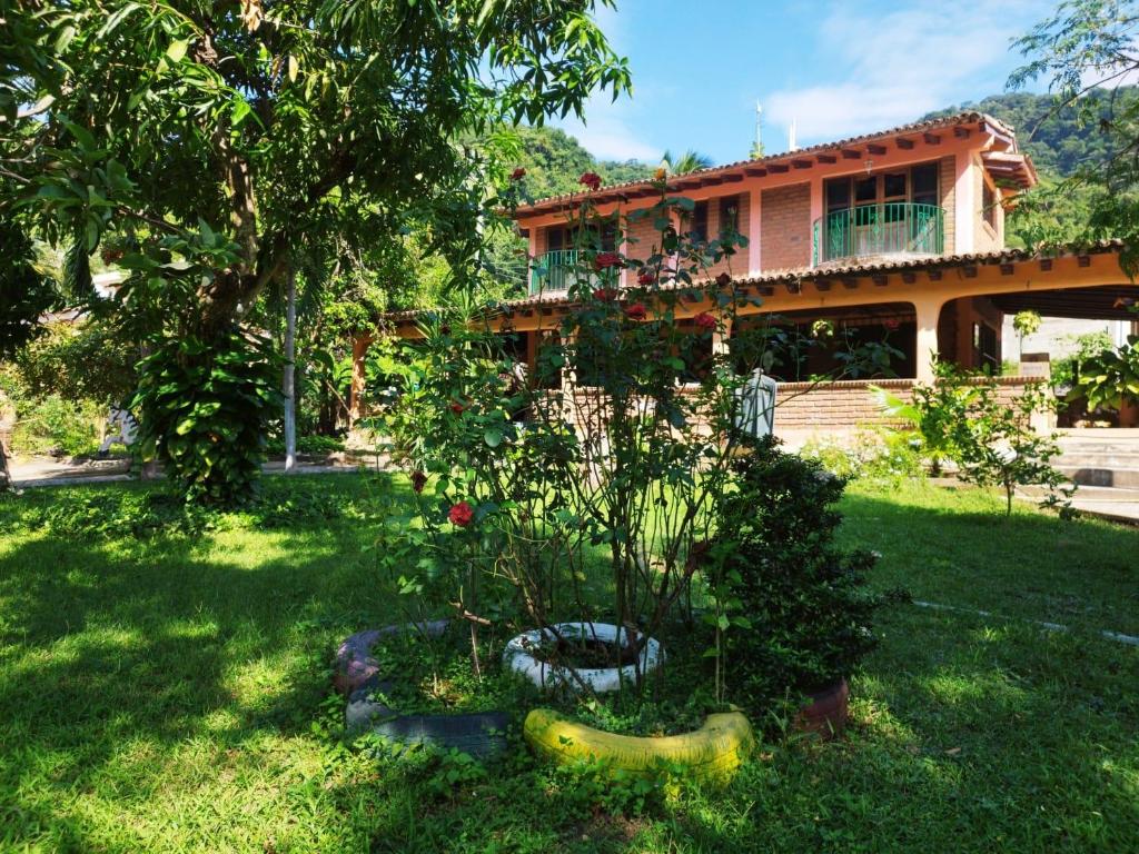 a house with a tree in the yard at Casa La Potranca in Puerto Vallarta