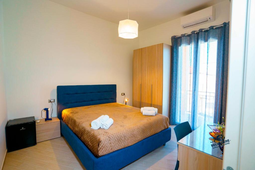 Postel nebo postele na pokoji v ubytování Belvedere Valle Mare