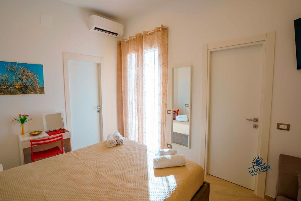 Postel nebo postele na pokoji v ubytování Belvedere Valle Mare