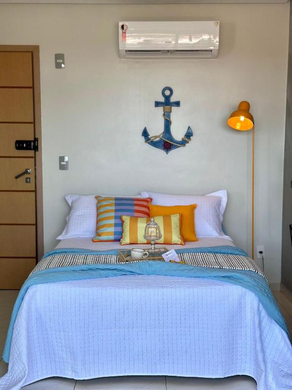 a bedroom with a bed with an anchor on the wall at (308) Studio Âncora | Your Refuge in Holandeses in Vinhais