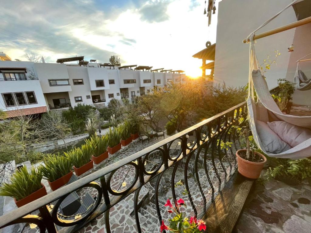 a balcony with a hammock and some plants and a building at Casa Itzae La Antigua Dog Friendly in San Miguel de Allende