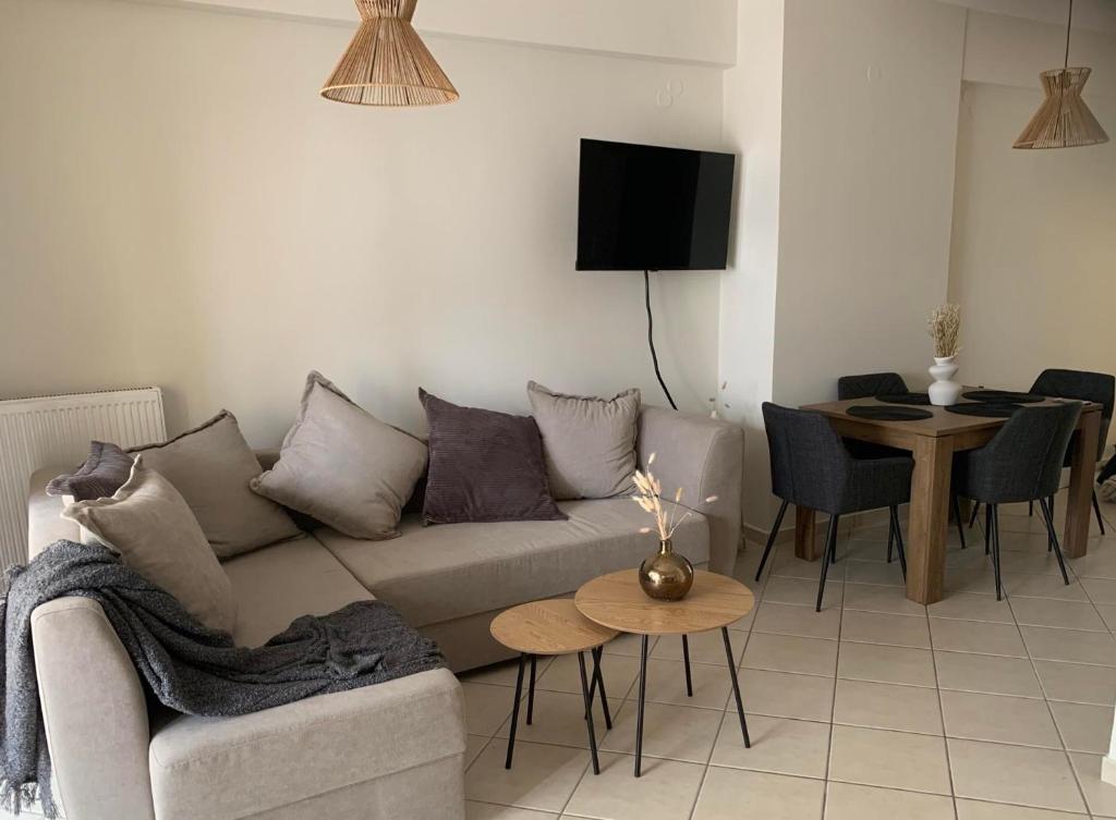 a living room with a couch and a table at Adeste to Ioannina Apartment in Ioannina