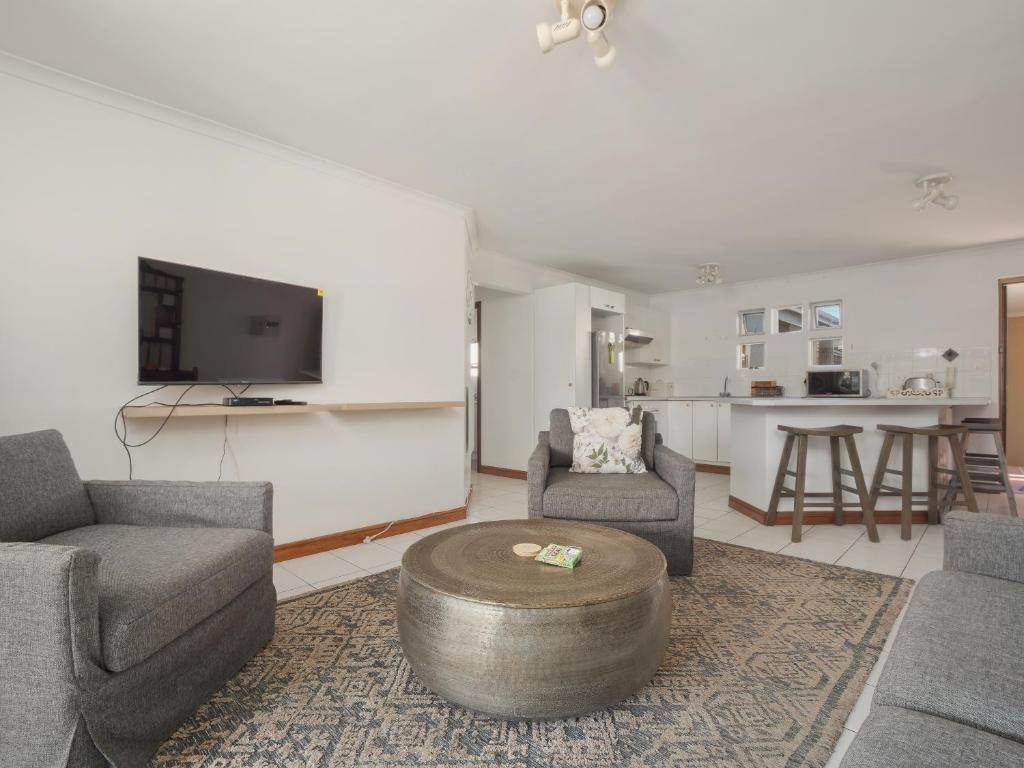 a living room with a couch and a coffee table at Summer Place in Knysna