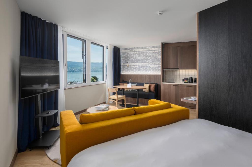a room with a bed and a yellow couch at The Yarn in Horgen