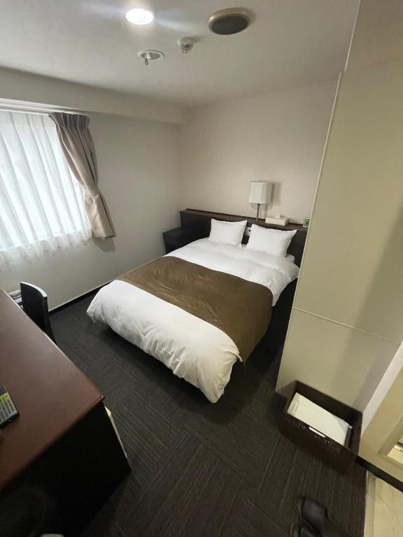 Postel nebo postele na pokoji v ubytování Takatsuki W and M Hotel
