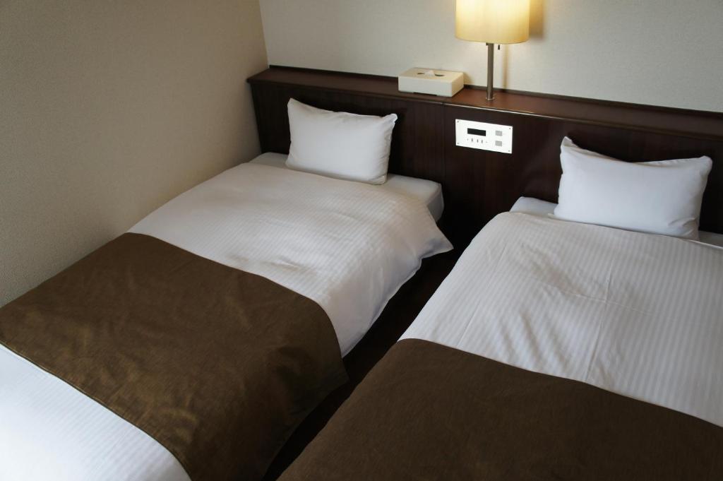Postel nebo postele na pokoji v ubytování Takatsuki W and M Hotel