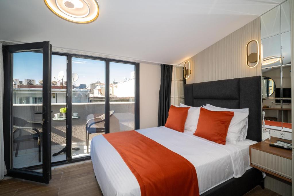 a hotel room with a bed and a balcony at Robin Hotel in Istanbul