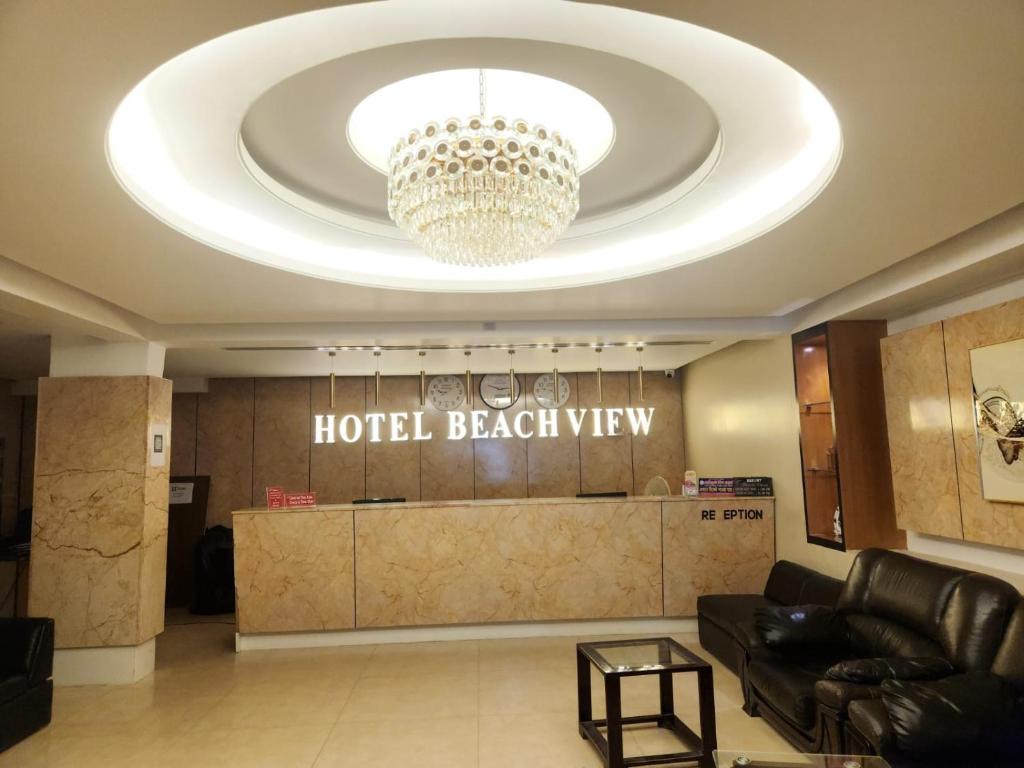 a lobby of a hotel with a chandelier at Resort Beach View in Cox's Bazar