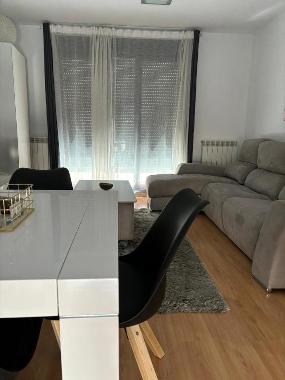 a living room with a white table and a couch at Casa Mercaderes in Logroño