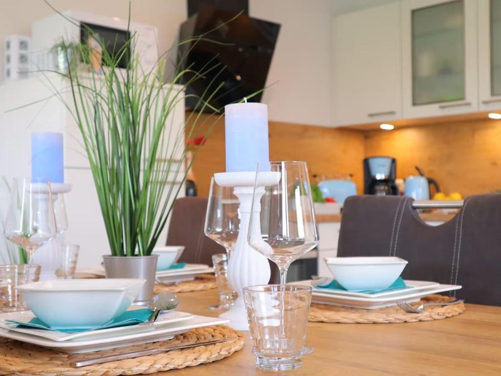 a table with plates and wine glasses on it at Ferienhaus Luv in Dorum Neufeld