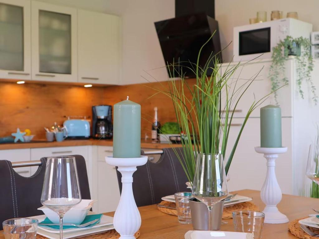 a table with three candles on top of it at Ferienhaus Lee in Dorum Neufeld