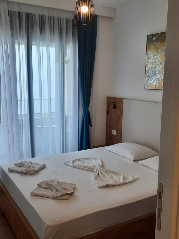 a bedroom with two beds and a window at Eagles Locus Apartments in Ulcinj