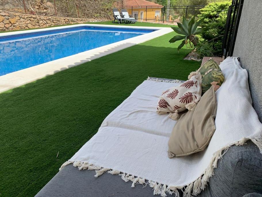 a white mattress sitting next to a swimming pool at La Casa de la Fuensanta in Murcia