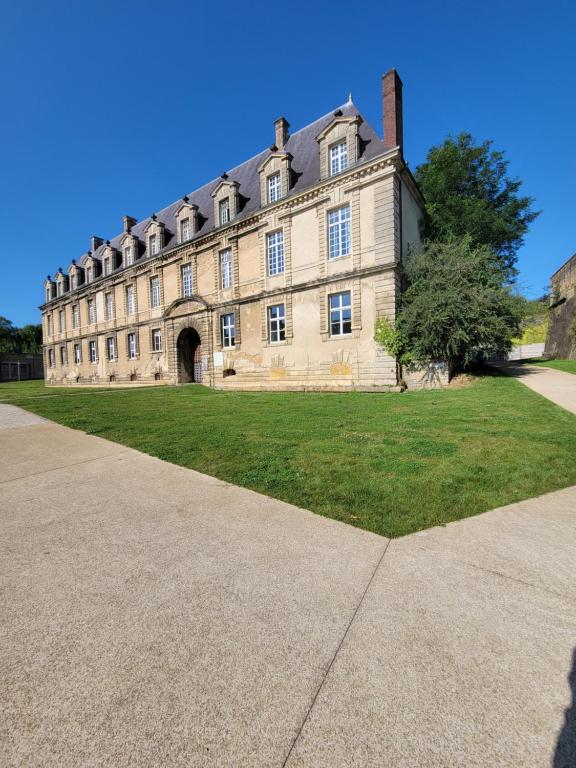 a large stone building with a large grass yard at Château des Princes " Calme et sérénité au cœur de Sedan " in Sedan