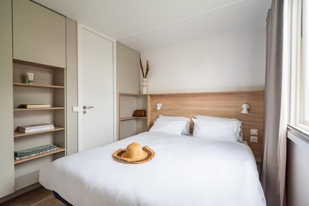 een hoed op een bed in een slaapkamer bij Camping Marvilla Parks Kaatsheuvel in Kaatsheuvel