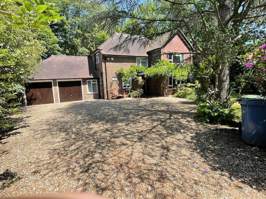 a house with a large driveway in front of it at Delux 5 bed house lots private car parking, short walk to high st, shops in Fleet