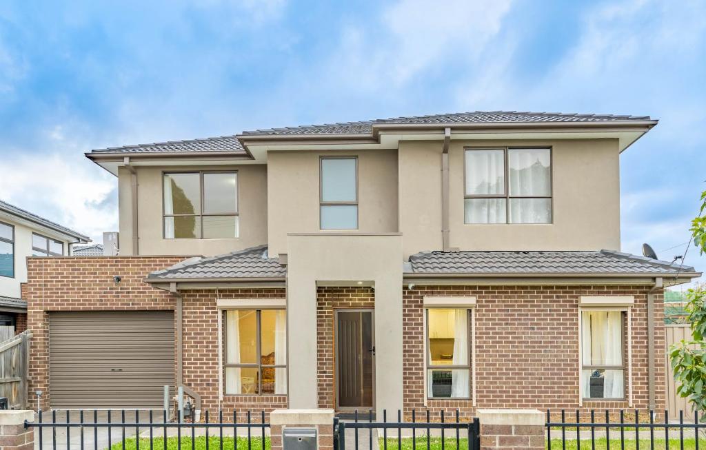 a house with a fence in front of it at Hidden Gem - 3 bedroom townhouse in Heidelberg West in Melbourne