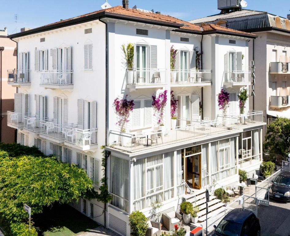 an apartment building with flowers on the balconies at Hotel Italia Boutique in Rimini
