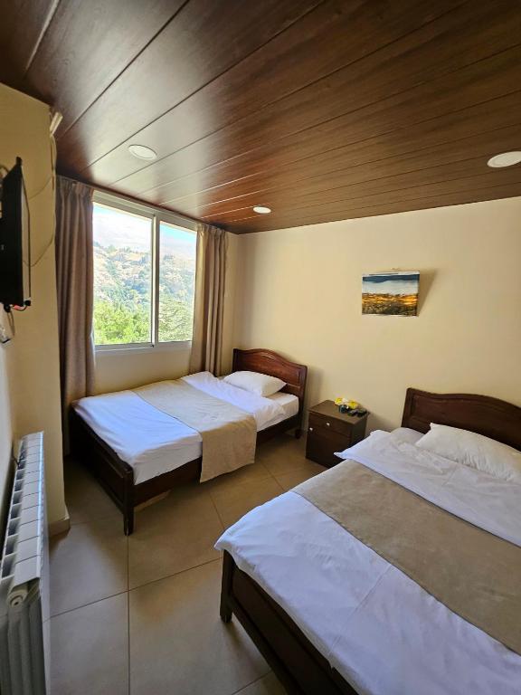 Postel nebo postele na pokoji v ubytování Hotel L'Aiglon