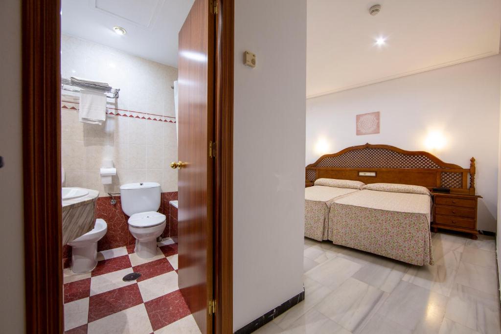 Postel nebo postele na pokoji v ubytování Hotel Los Omeyas