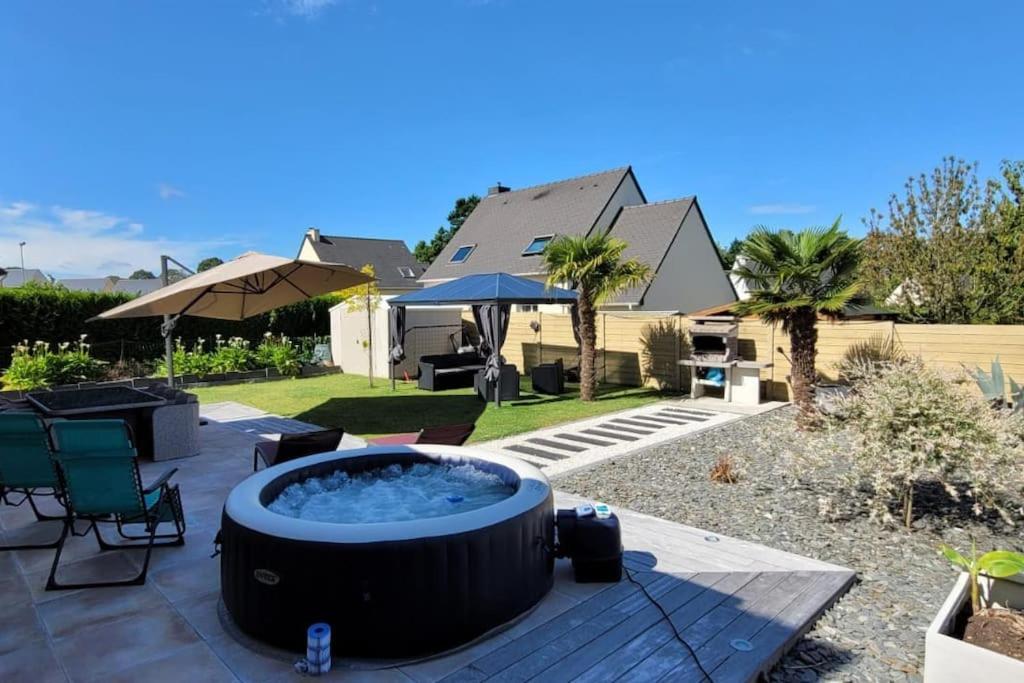 a hot tub in the backyard of a house at Maison 4 chambres pour 8 personnes in Dol-de-Bretagne